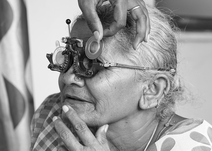 An elderly person getting an eye exam
