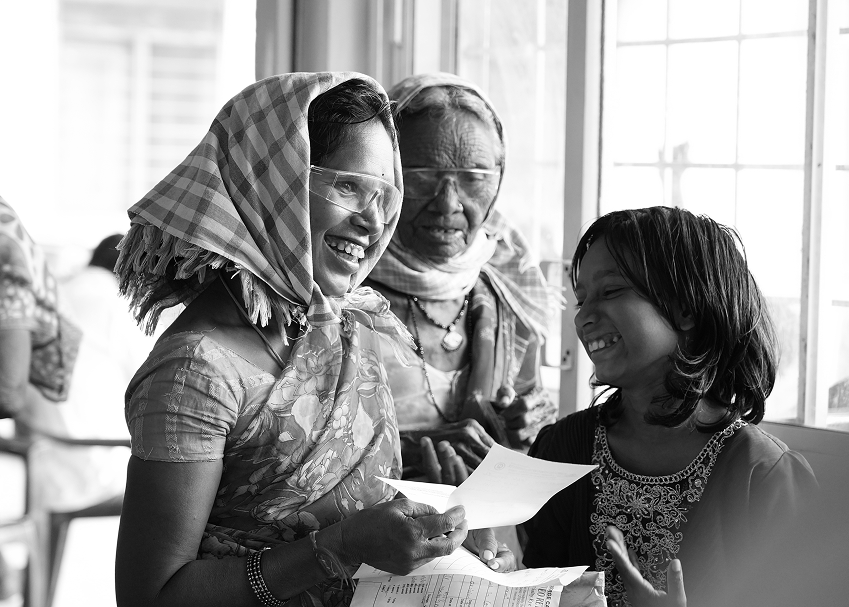 Elderly woman smiling during an eye exam