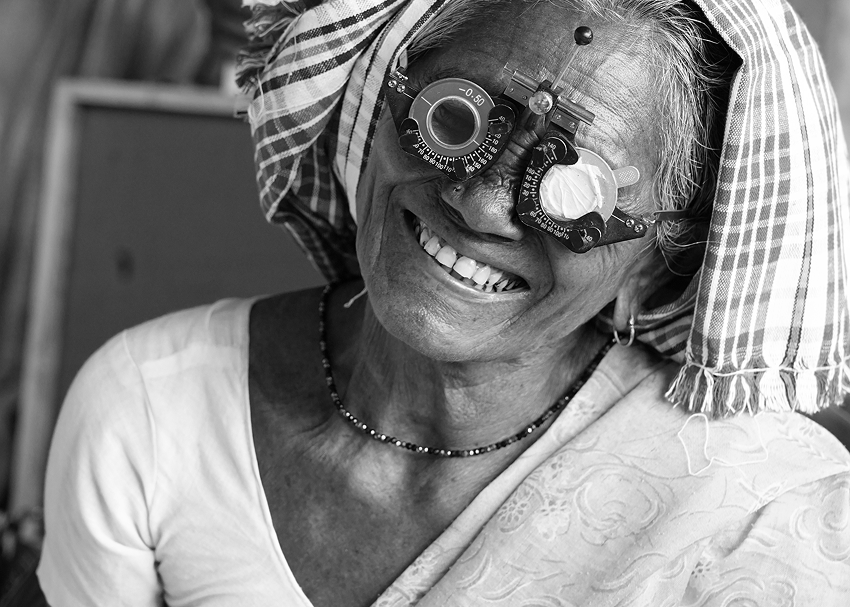 Elderly woman smiling during an eye exam